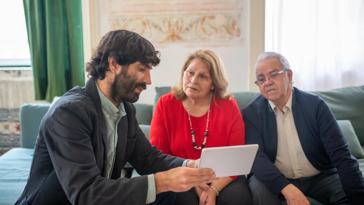 A solar consultant reviewing options with a homeowner outside a house