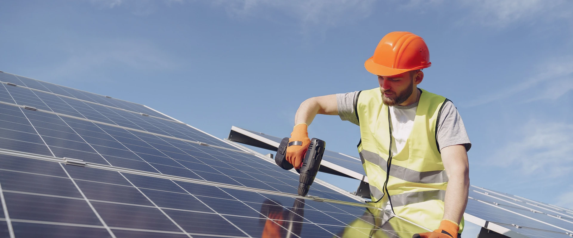 An installer fitting a solar panel on a residential roof