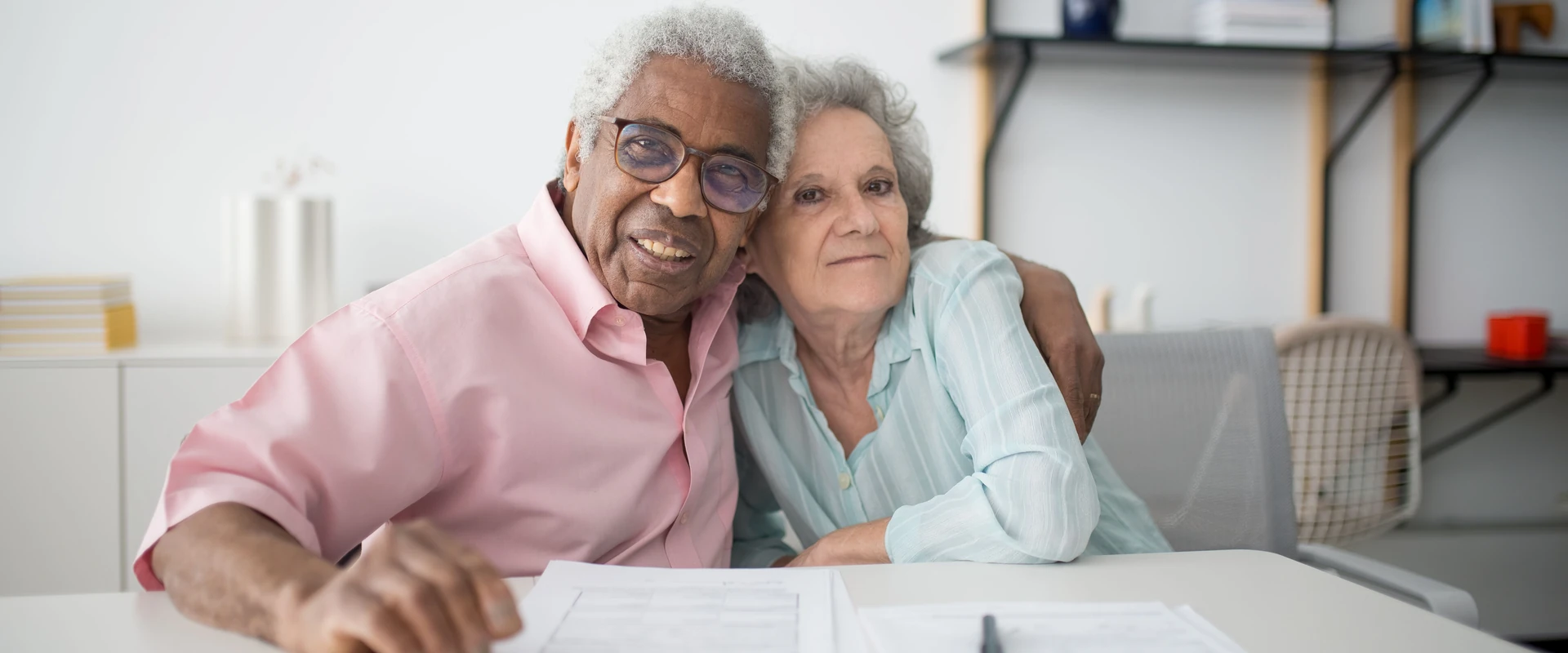 Two people reviewing financing paperwork at a table