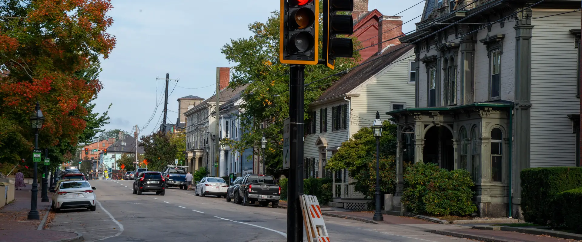 A street of historic clapboard houses lined with mature trees