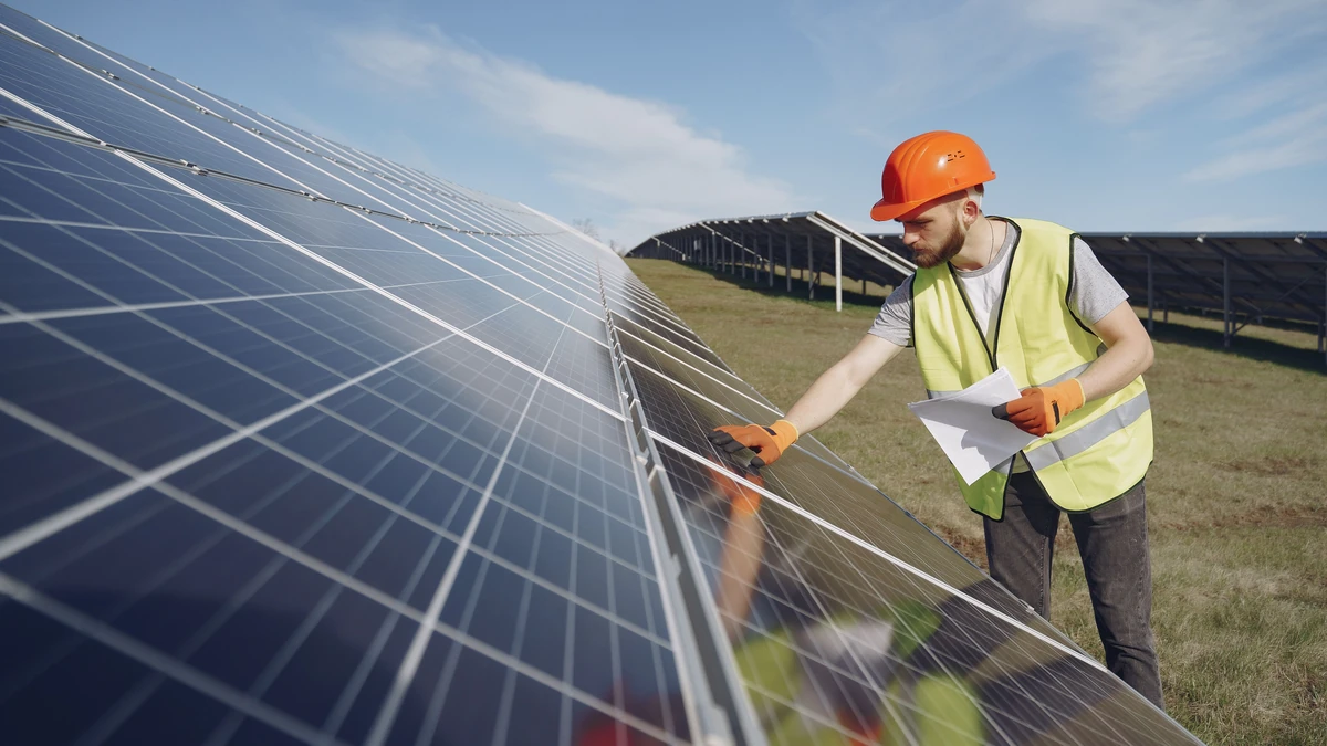 A technician inspecting a solar panel connection